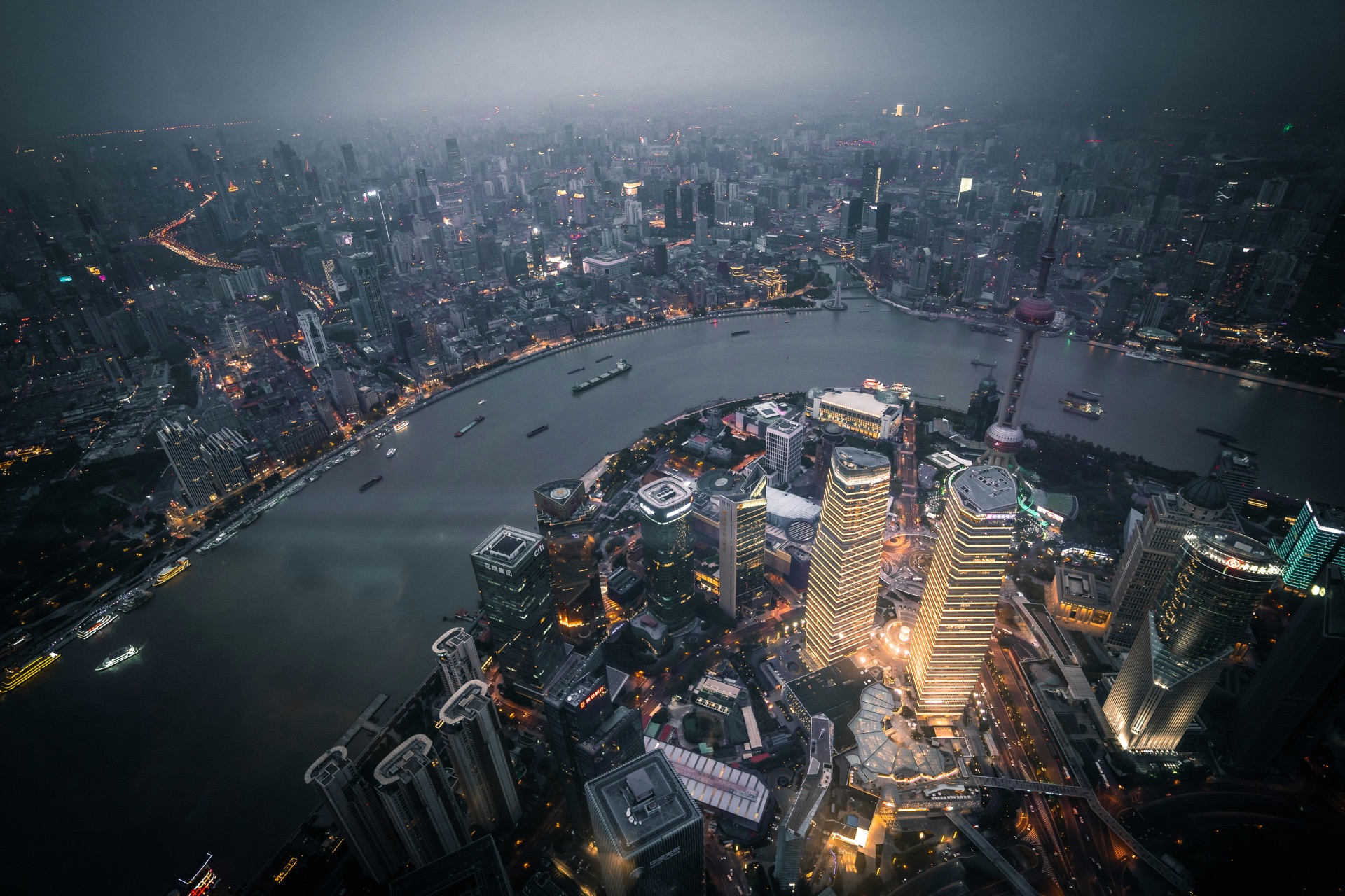 Dark aerial view of a city grid at night.